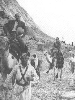 DEMILLE & CHUCK RIDING CAMELS HEADING FOR MOUNT SINAI