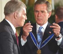 PRES.BUSH PLACING THE PRESIDENTIAL MEDAL OF FREEDOM  ON CHUCK-2003