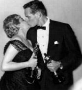 Chuck & Simone Signoret(Best Actress) Holding their 'Oscars'